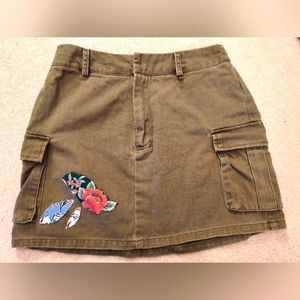 Olive mini skirt with cargo pockets and hand sewn floral pattern